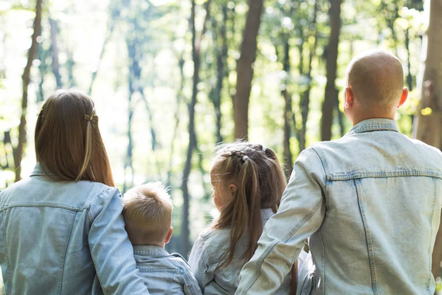 Rear view of young family sitting